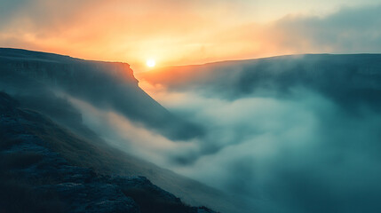 Fototapeta premium Mountain cliff overlooking fog-covered valley at dramatic sunrise with soft light