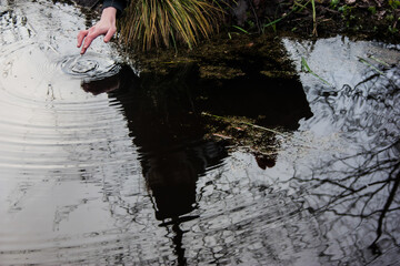 Reflection of a Mysterious Figure Touching Water
