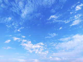 Clear blue sky texture and white fluffy cloud nature background. The sun shines bright in the daytime in summer