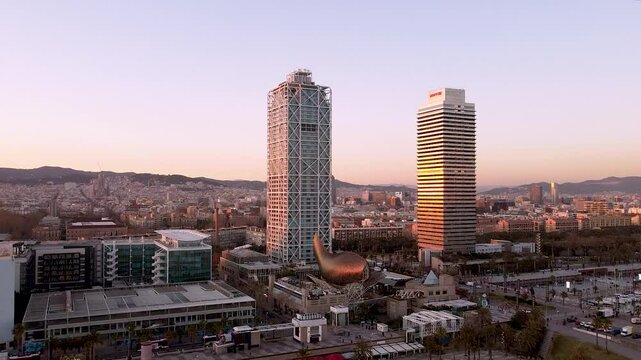 Barcelona, Spain - 5 February 2025: Aerial drone view of Barcelona at sunset. Dusk cityscape near Torre Mapfre and Hotel Arts towers. Sunset skyline. Marina street and Port Olimpic