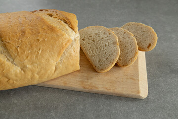 freshly baked bread loaf on wooden cutting board