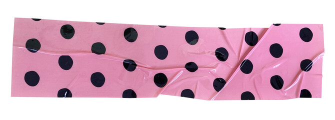 Crumpled torn pieces of pink background with black polka dots packing tape, adhesive sealing tape,...