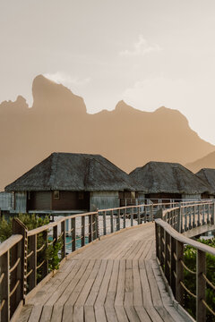 A winding boardwalk leads to dreamy overwater bungalows kissed by the golden sunset and framed by majestic peaks. Serenity luxury and island magic all in one breathtaking escape in Bora Bora