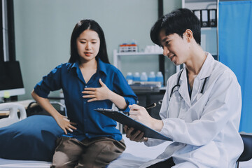 Obraz premium doctor consulting senior old patient filling form at consultation. Professional physician wearing white coat talking to mature woman signing medical paper at appointment visit in clinic.