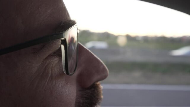 detail eyes with driver's glasses, with sunset reflection