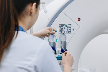 Back view of female doctor assists a patient undergoing an MRI scan, showcasing professionalism and...