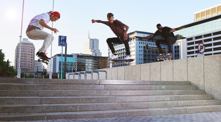 Friends, skateboard group and stunt jump in street, city or outdoors for practice. Men, steps and...