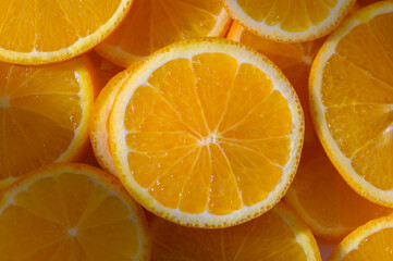 Vibrant orange slices arranged beautifully, showcasing juicy texture and freshness in a sunlit...