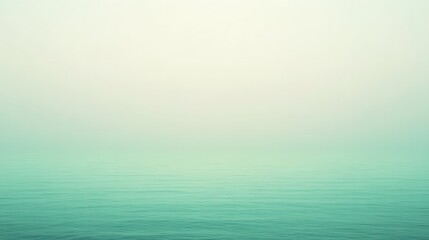 Obraz premium Calm turquoise water meeting a soft hazy cream sky