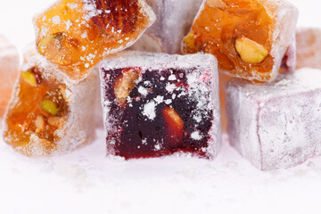Sweet food Turkish delight, assorted rahat locum in form of cubes with nuts and powdered sugar, traditional food, on white background