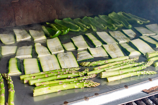 Barbecue of green peppers, zucchini and green asparagus. Outdoor smoked grill. BBQ. Horizontal image.
