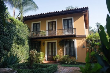 Charming yellow house with lush greenery