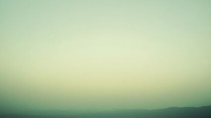 Faded green and yellow colors fill sky and distant mountains