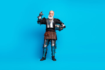 Elderly man in full knight armor striking a noble pose against a vibrant blue background, embodying...