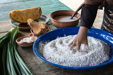 An Asian woman is making traditional cake dough