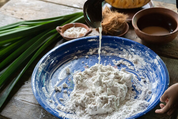 An Asian woman is making traditional cake dough