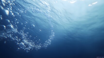 Bubbles rising in deep blue ocean water create a spiral