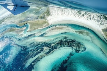 A breathtaking view from above of Shark Bay’s tidal dunes and water inlet, showcasing the natural beauty of Western Australia.
