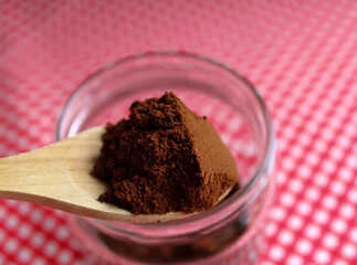 Ground coffee in spoon