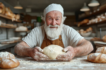 Elderly caucasian male baker smiling while kneading dough in rustic bakery