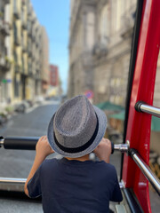 A young boy is enjoying a beautiful and scenic view while on an exciting bus tour