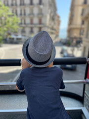A young boy is enjoying a beautiful and scenic view while on an exciting bus tour