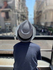 A young boy is enjoying a beautiful and scenic view while on an exciting bus tour