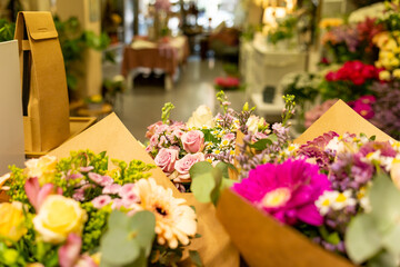 Flower shop displaying colorful bouquets wrapped in brown paper