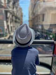 A young boy is enjoying a beautiful and scenic view while on an exciting bus tour