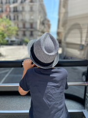 A young boy is enjoying a beautiful and scenic view while on an exciting bus tour
