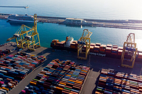 Barcelona, Spain- 5 February 2025: Aerial view of shipping containers and cargo ships in the sea port of Barcelona in Spain, Europe. Concept of sea and maritime trade and trade war due to tariffs.
