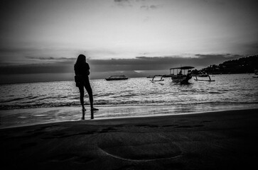 Silhouette of a Woman on a Beach at Sunset, Black and White Photography
