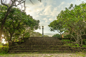 Stairs in the forest on top of a mountain at sunset