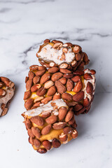Vegan Turkish delight on a light background, Turkish delight with nuts, almonds, pistachios, dried fruits, Turkish sweets, nut nougat