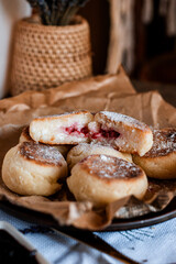 cheesecakes with raspberry jam, Ukrainian cuisine, rustic style, cutlets with sauce, cozy light still life, lunch, home cooking