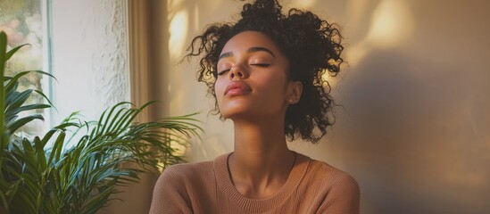 Relaxed young woman enjoying tranquility in a cozy indoor space with natural lighting and room for textual content