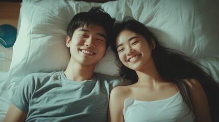 Young Asian couple enjoying a relaxed afternoon in bed, capturing a moment of intimacy and the beauty of their marital bond