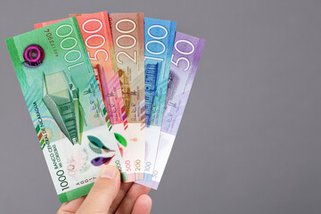 Nicaraguan money in the hand on a gray background