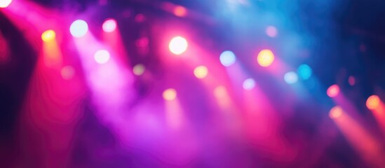 Colorful concert stage lights defocused background with soft blur for design and creative projects related to music and entertainment.