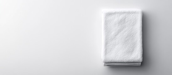 Folded white towel mockup for product branding showcasing texture design in home bath decor isolated on neutral background for presentation.