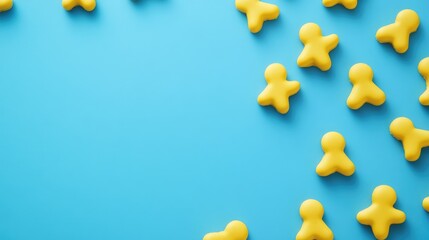Obraz premium Playful yellow figures arranged on a vibrant blue background with ample empty space for text or design elements.