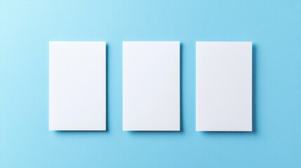 Fototapeta premium Three empty white vertical business cards arranged on a blue background for customizable branding and design mockups