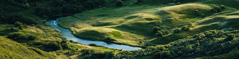 Obraz premium Aerial View of River in Rolling Green Valley