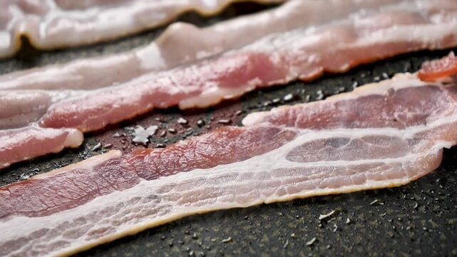 Slice of Bacon Grilling on a grill