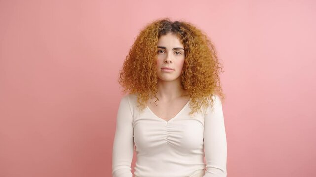 Young woman showing different facial expressions on pink background