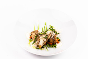 Gourmet Dish with Meat, Vegetables, and Garnishes on White Background