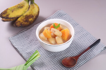 Kolak pisang is Indonesian traditional dessert made of banan and sweet potato with palm sugar sauce. Selective focus
