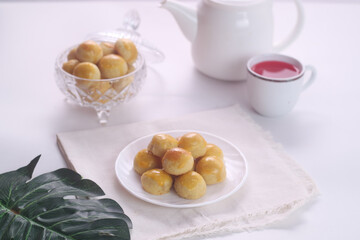 Kue nastar or pineapple tart. indonesian eid snack. on a white plate. bright mood style. perfect for recipe, article, catalogue, or any commercial purposes.
