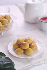 Kue nastar or pineapple tart. indonesian eid snack. on a white plate. bright mood style. perfect for recipe, article, catalogue, or any commercial purposes.
