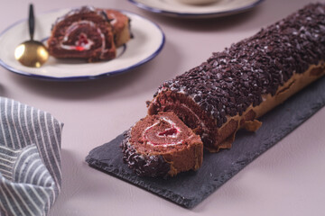 Chocolate Sponge rolls filled with jam and cream and chocolate topping, tastes sweet, soft and delicious,selective fosus,soft focus texture